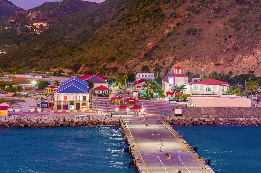 Night view of the Cruise Port on Grand Turk, with soft light illuminating the water and surrounding landscape.