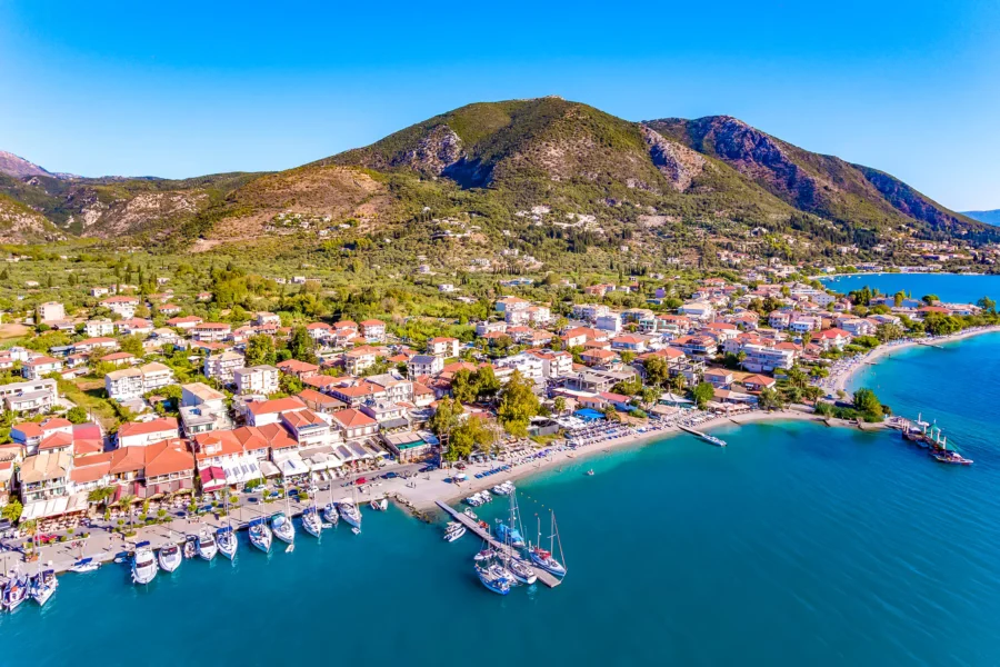 Lefkada Town harbor view with boats and colorful buildings at sunset.