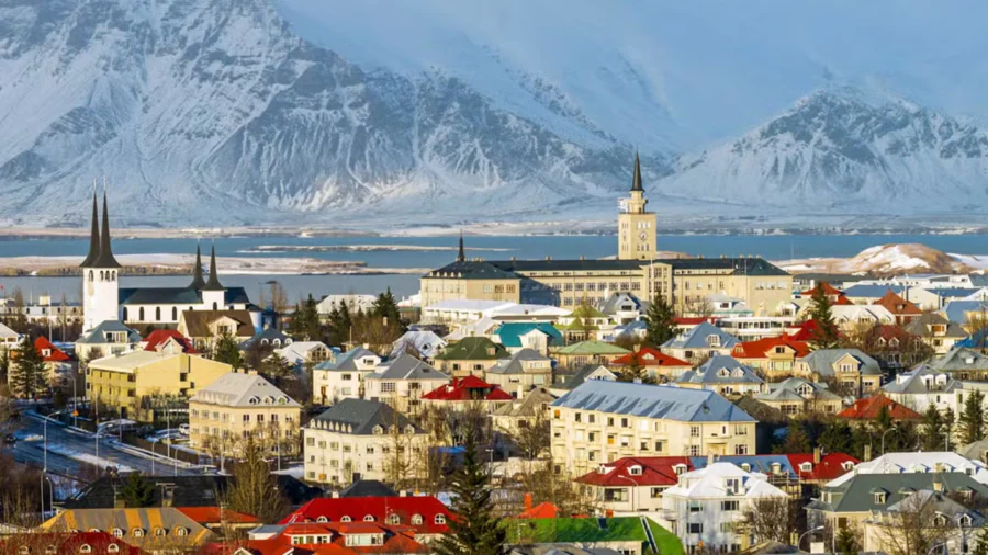 Reykjavik cityscape view during sunset with colorful buildings and scenic landscapes.
