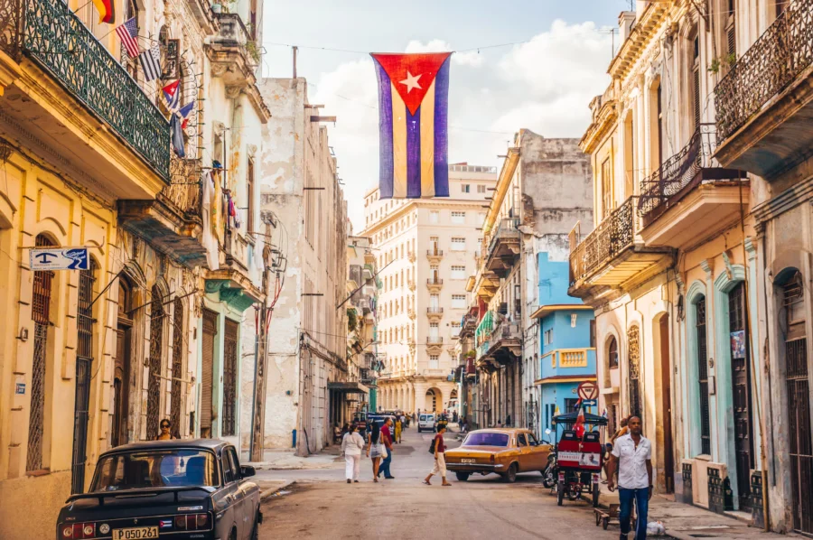 Havana street scene: classic cars, vibrant architecture, rich Cuban culture.