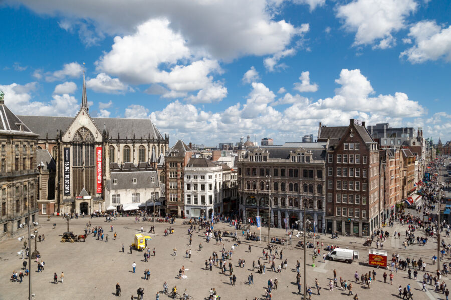 Aerial view of Dam Square in Amsterdam, showcasing its historic buildings and bustling atmosphere
