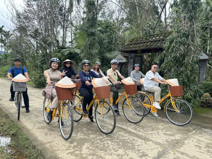 Cyclists riding together on a path, enjoying a day trip to Loc Yen Ancient Village.