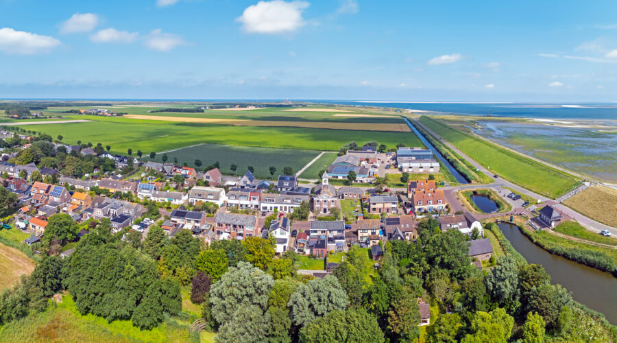 Aerial view of De Cocksdorp, a town on Texel island in the Netherlands, showcasing its landscape and surrounding nature.