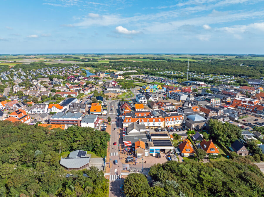 Aerial view of De Koog, a coastal town on Texel Island in the Netherlands, showcasing its beaches and surrounding landscape.