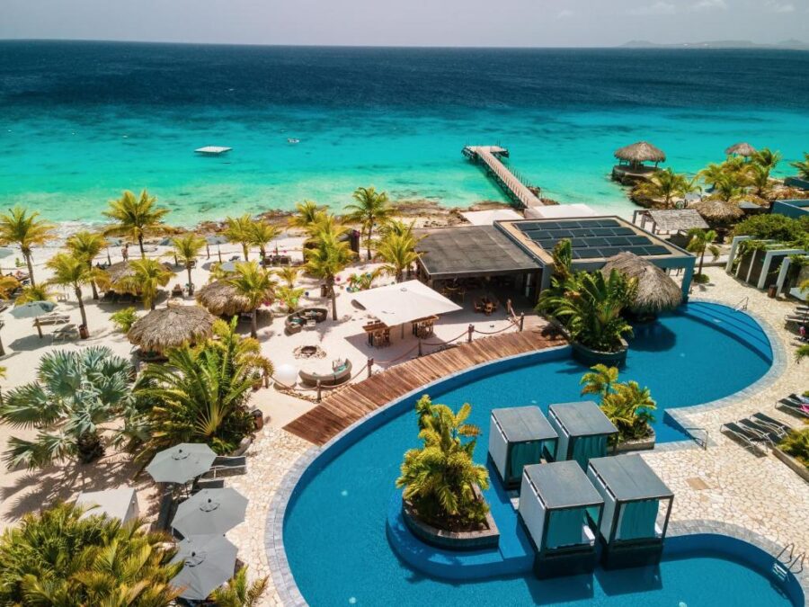Aerial view of Delfins Beach Resort in Bonaire, showcasing the resort and surrounding beach area
