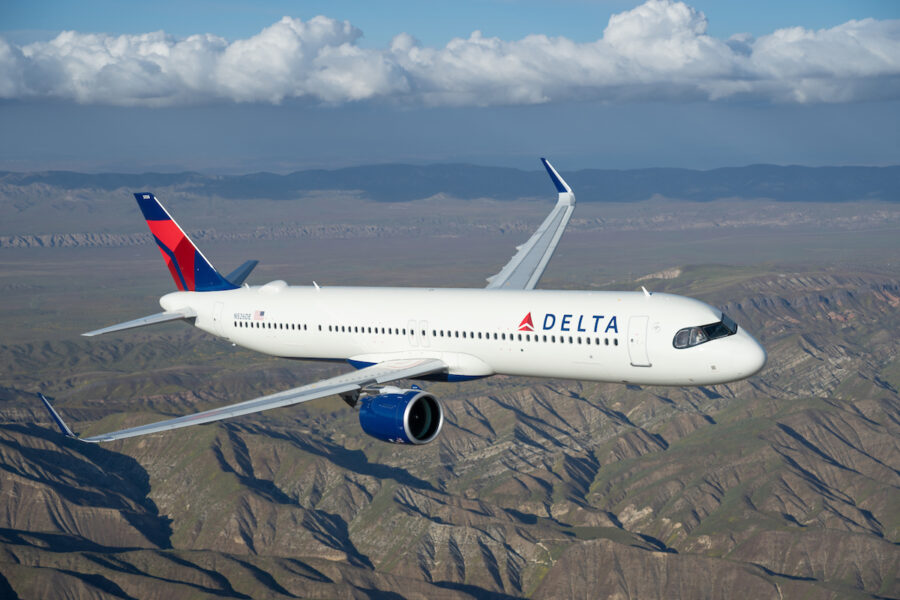 Delta Airlines Airbus A321neo flying over mountains, embodying modern aviation and adventure.