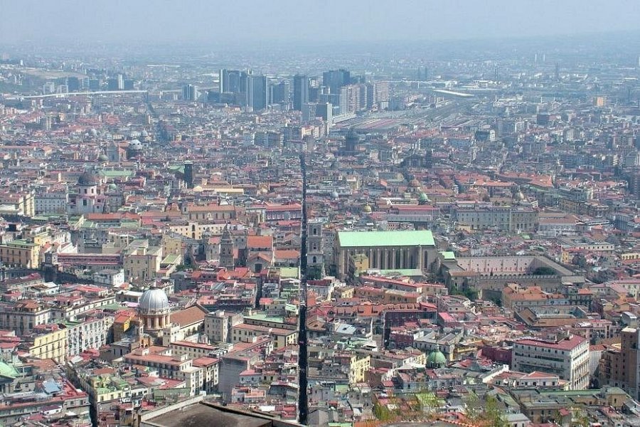 Aerial view of Naples dense historic rooftops and narrow Spaccanapoli street.
