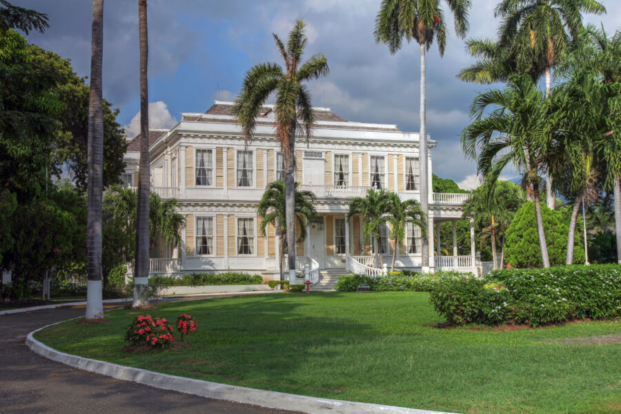 Exterior view of Devon House in Kingston, Jamaica, showcasing its historic architecture and lush garden landscape