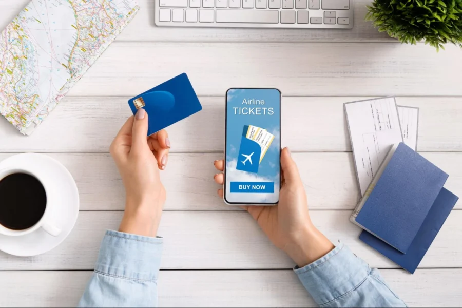 Travel planning with smartphone, passports, roadmap, coffee, and modern workspace.