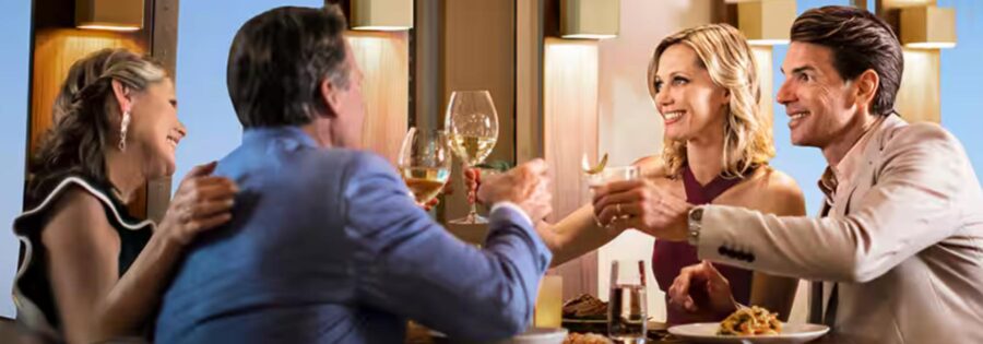 Celebratory dining scene with four friends toasting in an elegant restaurant.