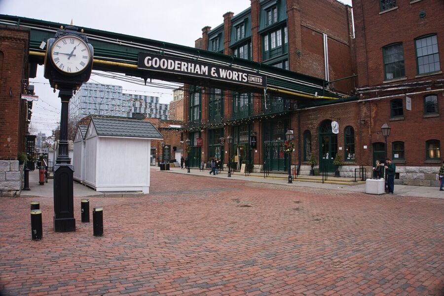 Vintage clock situated on a brick path outside a building in Toronto's Distillery District.
