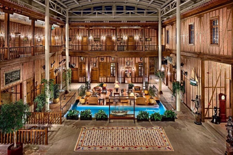 Atrium of Divan Cukurhan Ankara hotel featuring a pool and elegant wooden floors.