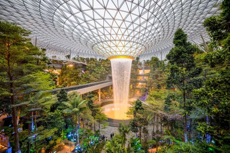 HSBC Rain Vortex, worlds tallest indoor waterfall, surrounded by lush greenery at Jewel Changi Airport.