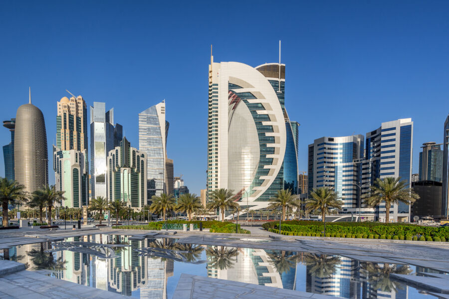 Scenic view of West Bay along the Corniche in Doha, Qatar, showcasing modern skyscrapers and a vibrant waterfront