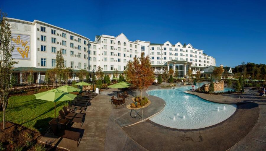 Scenic view of Dollywood's DreamMore Resort and Spa by the lake, showcasing lush greenery and tranquil waters.