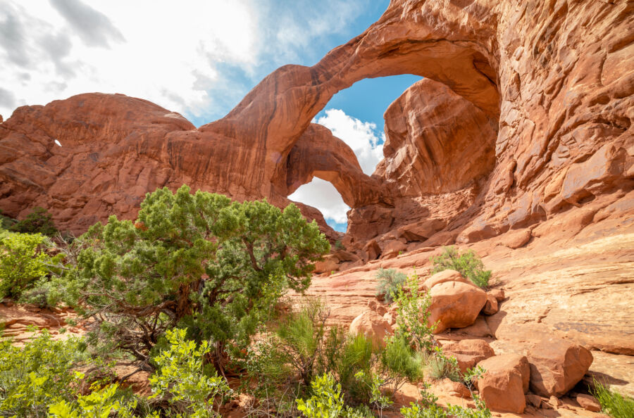 Double Arch in Arches National Park, Utah, features a stunning natural stone formation under a clear blue sky