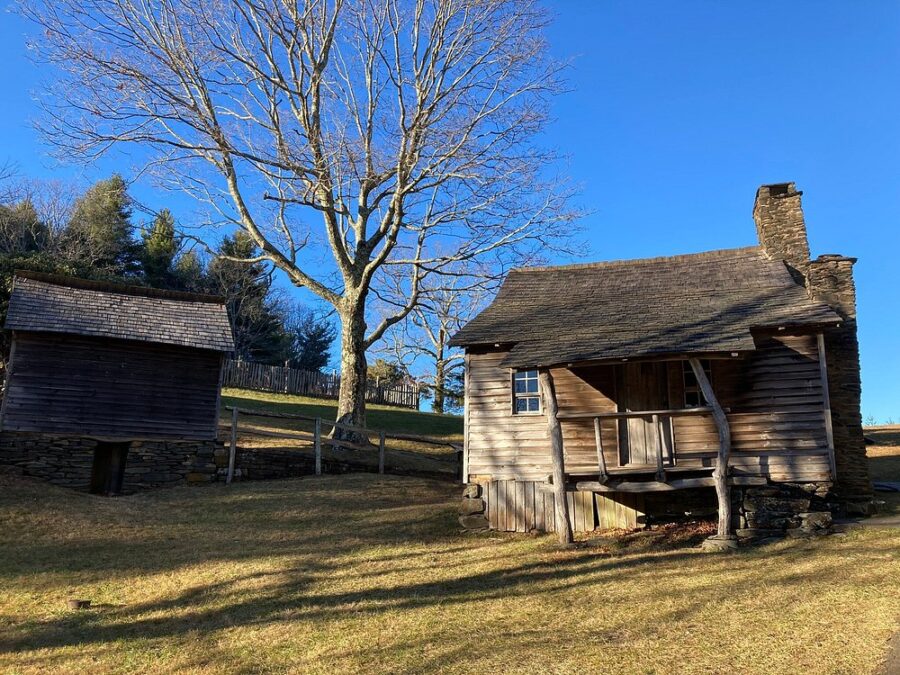 Two old wooden houses nestled in the countryside at Doughton Park Campground and National Recreation Area.