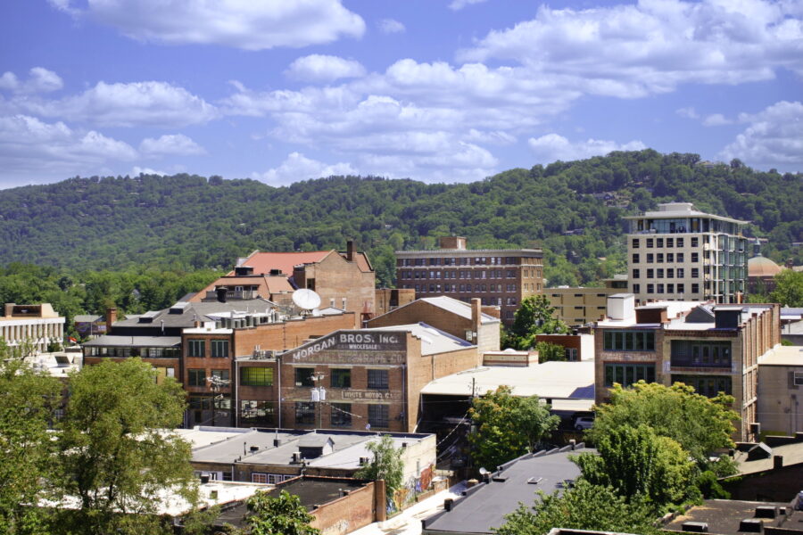 Downtown Asheville, North Carolina, features charming architecture, lively shops, and a scenic backdrop of the Blue Ridge Mountains.