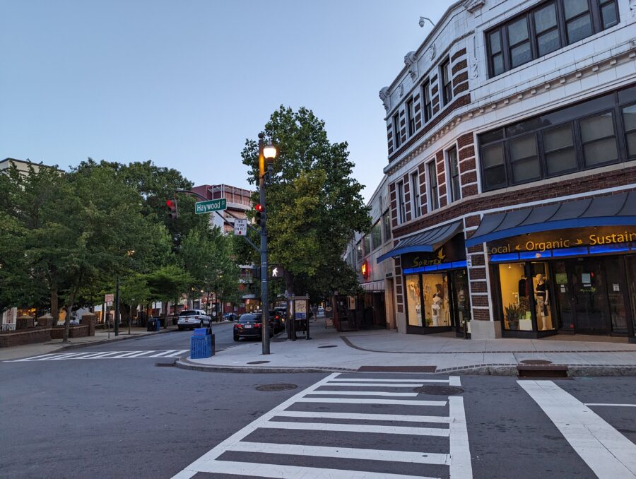 Downtown Asheville street scene with a decorative clock prominently displayed on a building.