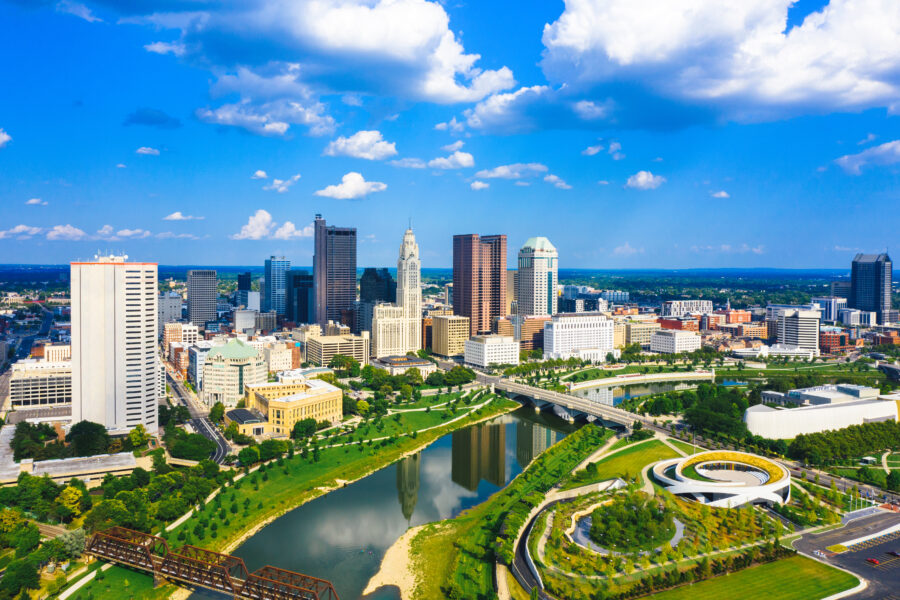 Aerial view of Downtown Columbus, Ohio, showcasing the skyline and the winding Scioto River below