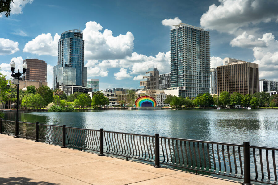 Scenic paths along the water at Lake Eola Park in downtown Orlando, Florida, surrounded by lush greenery and city views.