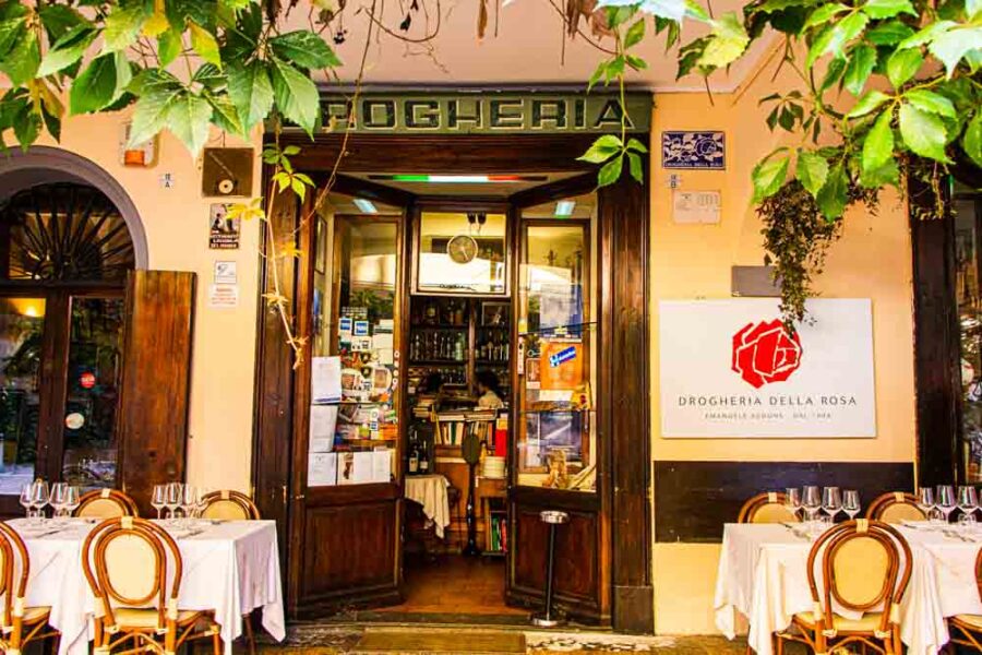 Bologna Italian cafe Drogheria Della Rosa with outdoor tables and wine glasses.