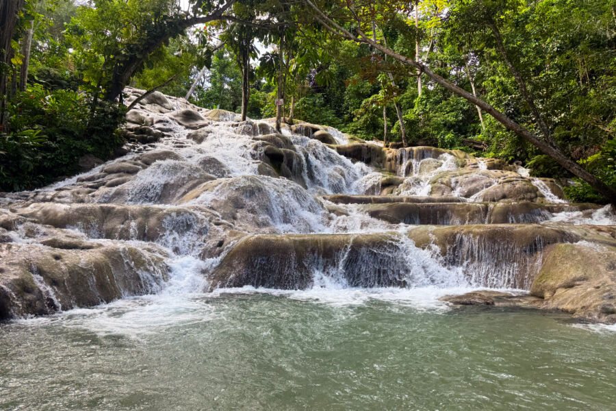 Scenic Dunn's River Falls in Ocho Rios, Jamaica, featuring vibrant greenery and flowing water in a tropical paradise