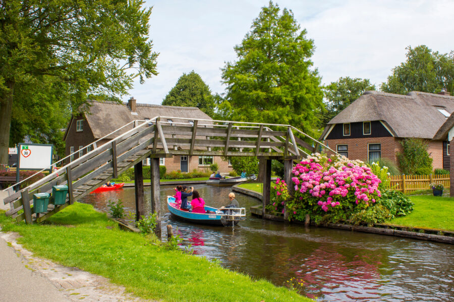 Scenic view of Giethoorn's historic old town featuring charming canals and thatched-roof houses.