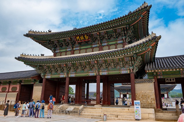 Traditional Korean architectural gate with tourists, vibrant colors, cultural heritage, historical significance.