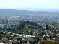 Edinburgh skyline featuring historic Edinburgh Castle, diverse architecture, and scenic hills.