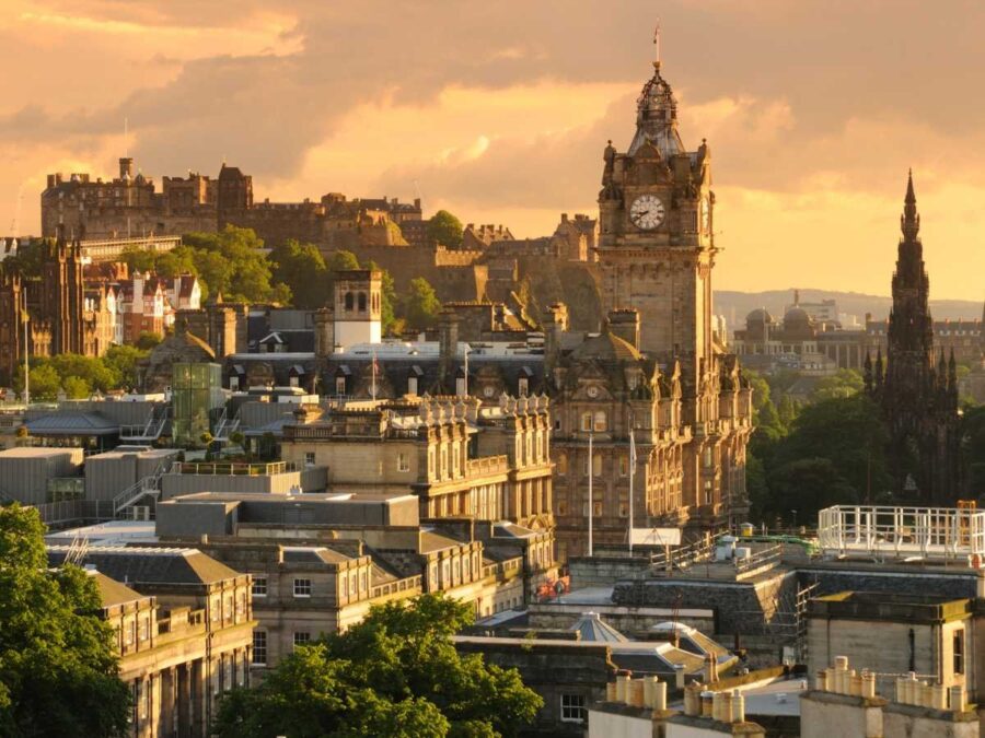 Edinburgh sunset skyline: historic architecture, Balmoral Hotel, Edinburgh Castle, vibrant cityscape.