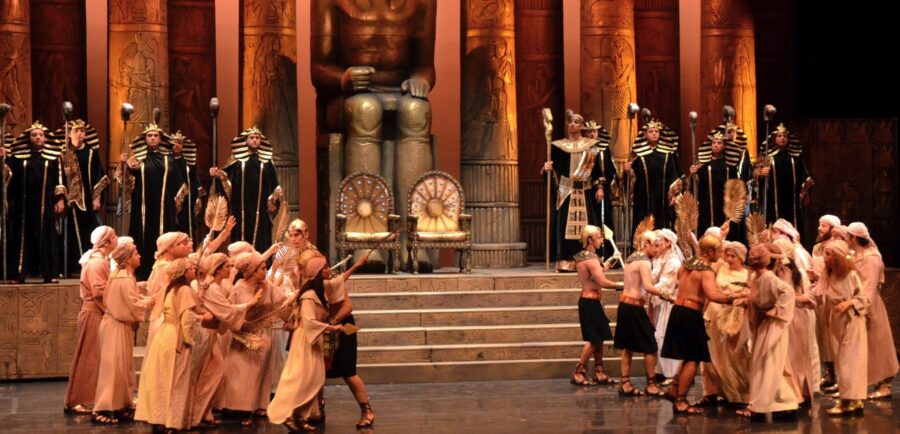 Antalya State Opera stage: Egyptian throne hall with pharaoh statue and costumed performers.