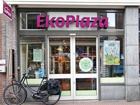 Bicycle parked in front of the Ekoplaza store in Amsterdam, showcasing a sustainable shopping environment.