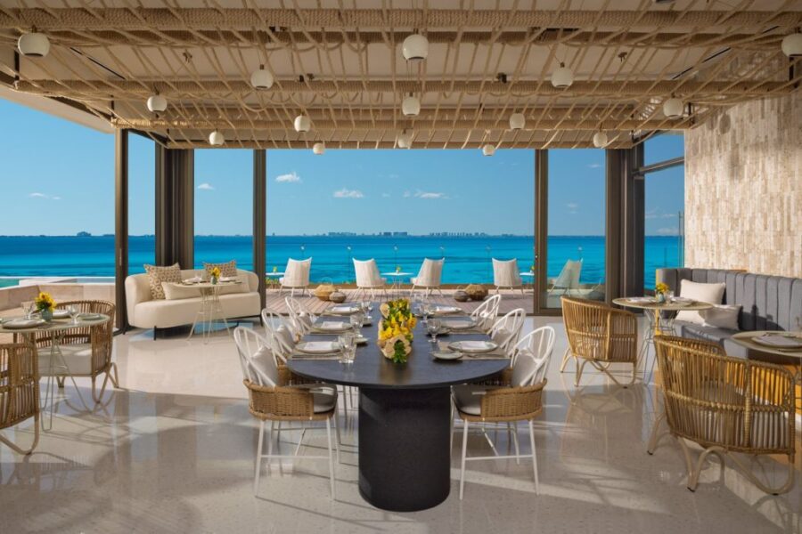 Ocean-view dining room with modern design, natural light, and elegant furnishings.
