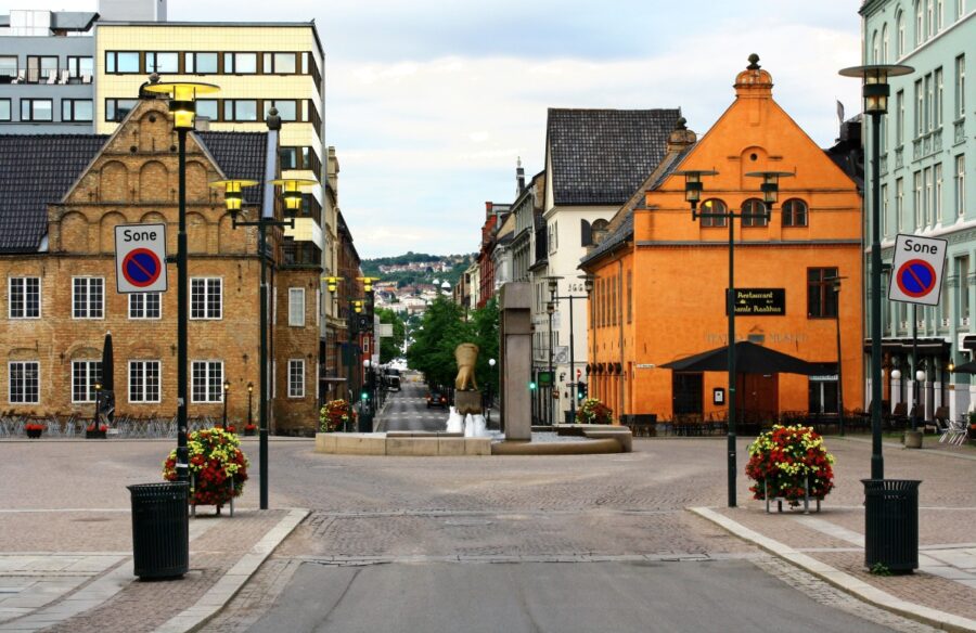 Kvadraturen cobblestone square with fountain and colorful historic buildings.