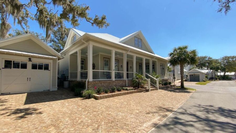 Coastal home with a driveway and garage, located in Endless Summer Ocean Oaks, Jekyll Island.
