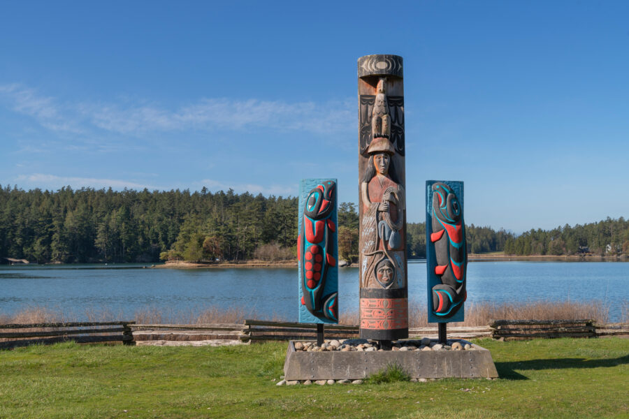 Coast Salish totem poles stand tall at English Camp, San Juan Islands National Historical Park, showcasing indigenous artistry.
