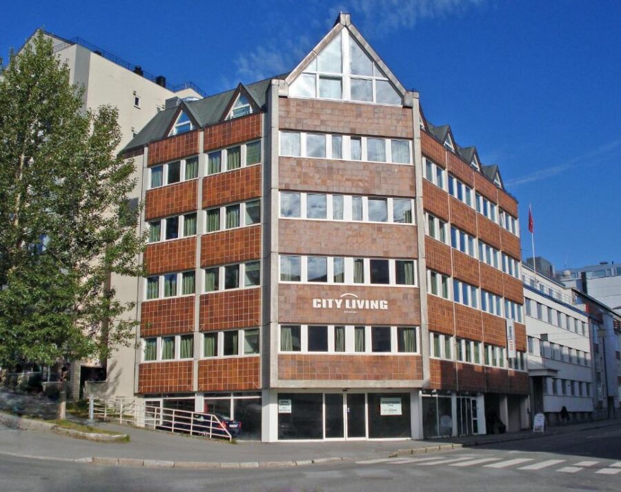 City Hotel Tromso in a quaint town on a lake's shore, showcasing the serene beauty of Norway's natural landscape.
