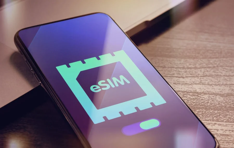 Modern smartphone showcasing eSIM technology on a wooden table, highlighting travel connectivity solutions.