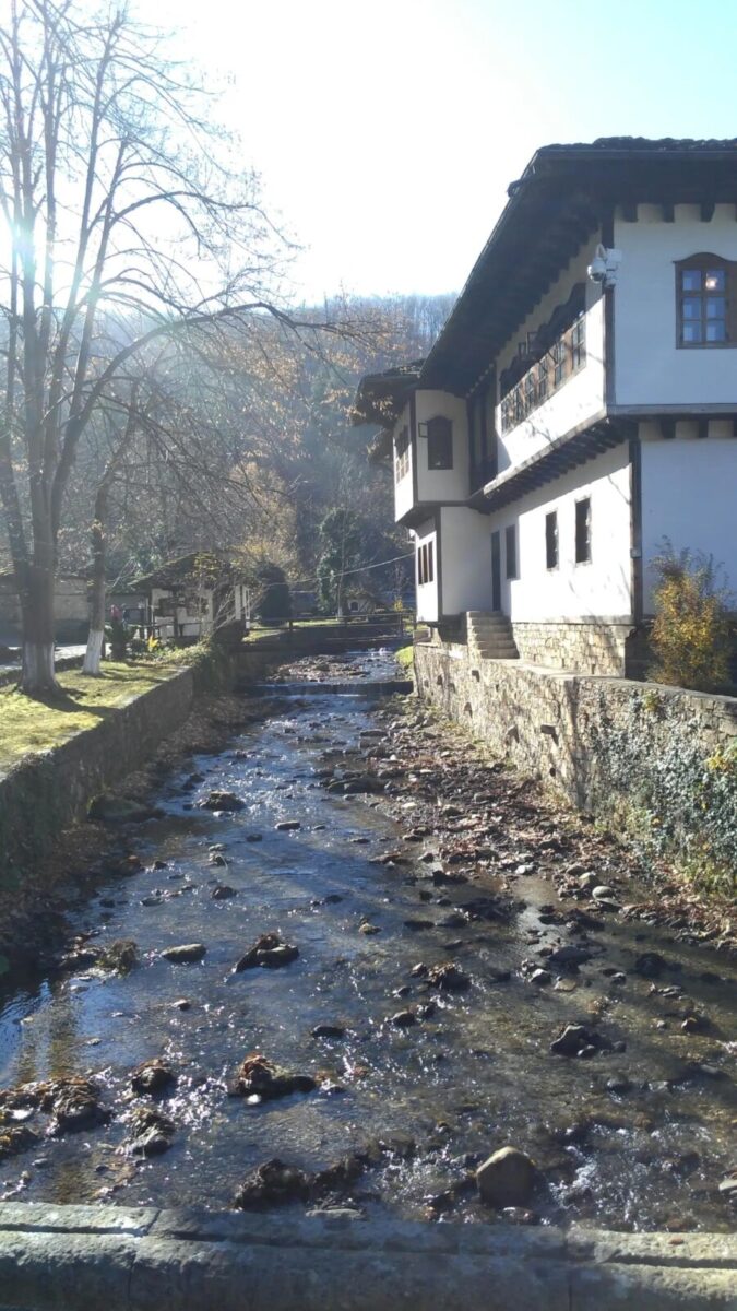 River flows through a small town, with the Ethnographic Museum Garbrovo visible along the banks.

