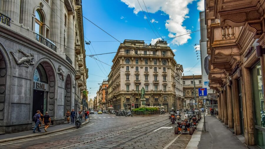 Vibrant European city street with classic architecture, pedestrians, and urban transport.