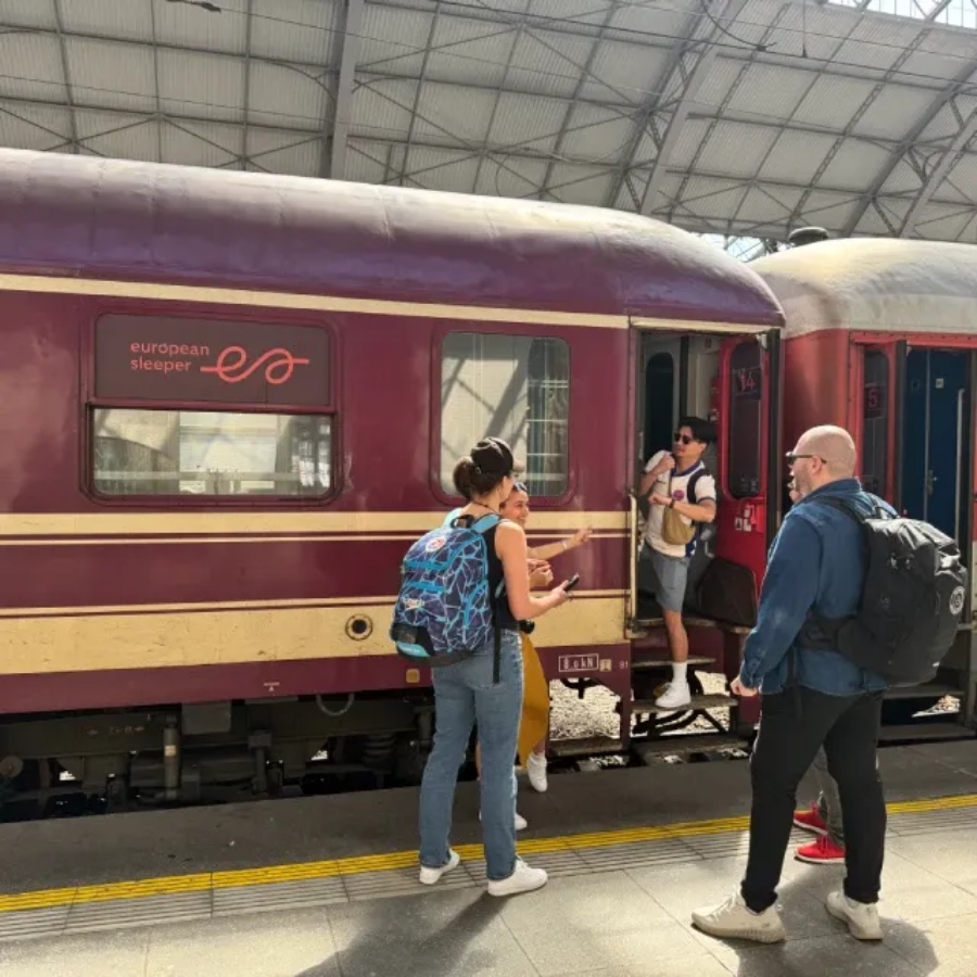 Passengers boarding the European Sleeper Train, carrying luggage and preparing for their overnight journey.

