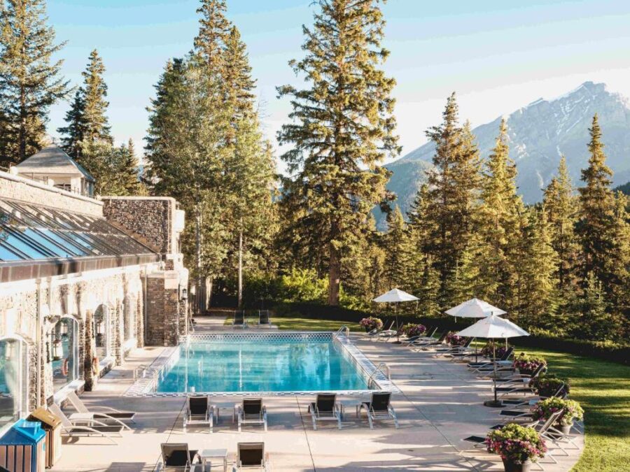 The exterior of the Fairmont Banff Springs Resort lodge, showcasing its grand architecture against a mountain backdrop.
