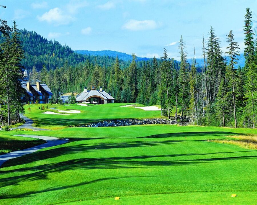 Fairmont Chateau Whistler Golf Club, showcasing a lush golf course with trees and a mountain in the distance.
