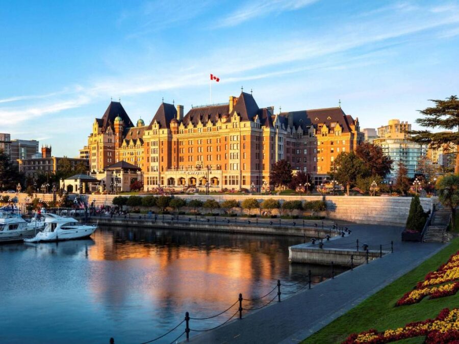 Fairmont Empress Hotel in Victoria, BC, showcasing its iconic architecture and lush surrounding gardens.
