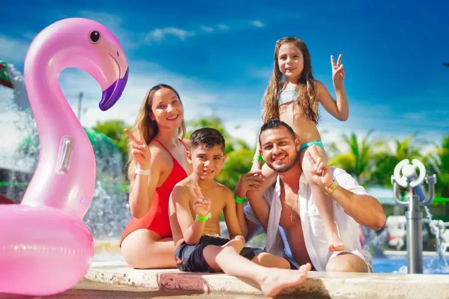 Happy Family Sitting on Poolside during a vacation