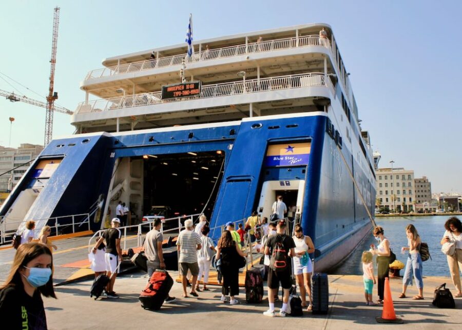 Piraeus ferry boarding at port, Blue Star vessel in Greece with passengers and luggage.