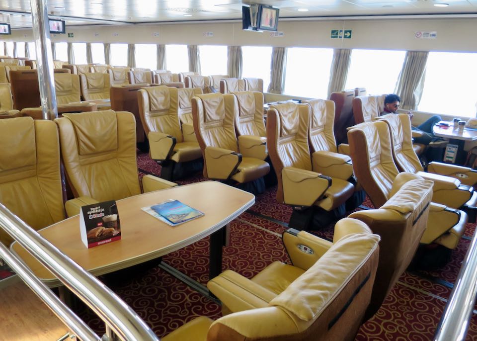 Luxury ferry interior with leather seats, ample space, natural lighting, and entertainment features.