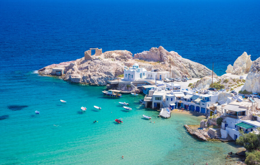 Scenic view of Firopotamos village, featuring Cycladic-style sirmata houses by the sea on Milos island, Greece.