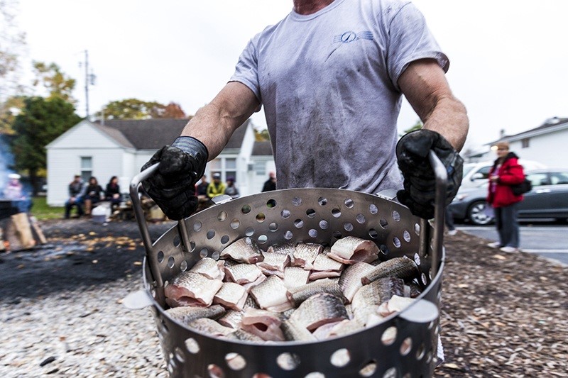 Man carrying fish bowl filled with fish